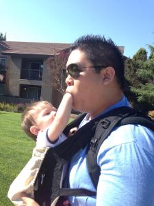 Ben plays with his son in an Ergo