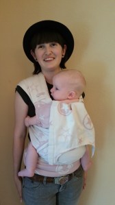 Giving the adjustments some wear with a borrowed baby. Check out the Superman Cape. :)