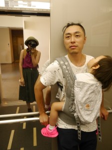 Proud papa with a sleeping toddler in a Tokyo elevator